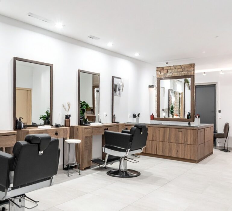 Elegant salon reception area with gold accents and French-style chairs