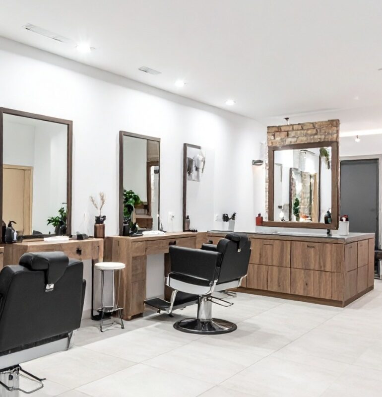 Elegant salon reception area with gold accents and French-style chairs