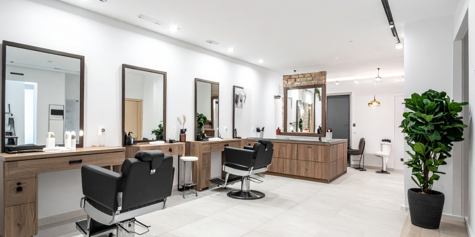 Elegant salon reception area with gold accents and French-style chairs